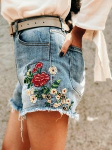 deal jeans, E2O bags, denim shorts, embroidered shorts, jean shorts, floral embroidery, floral shorts, denim cut offs, cut out sweat, cut out blouse, tassel bag, tan sling bag, beige boots, street style, pfw, fashion week, casual look