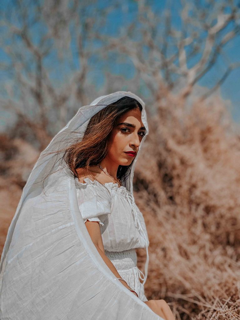 Outdoor editorial fashion shoot with girl in white dress & veil