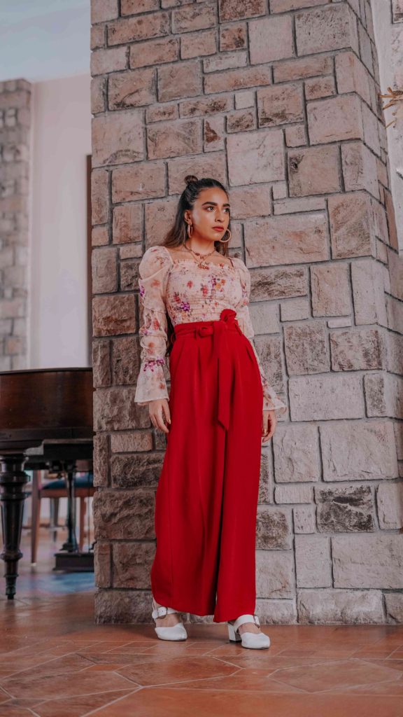 girl wearing nude floral top with red formal pants summer street style